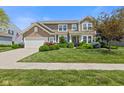 Charming two-story home with landscaped yard and attached two-car garage at 1294 Vista Way, Greenwood, IN 46143