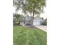 Charming two-story home with a well-manicured lawn, inviting porch, and a two car garage at 1378 Runningbrook Dr, Avon, IN 46123