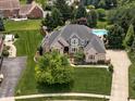Expansive home with a pool, playground, and lush landscaping at 13888 Smokey Ridge Dr, Carmel, IN 46033