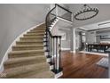 Elegant foyer featuring a curved staircase and hardwood floors at 13888 Smokey Ridge Dr, Carmel, IN 46033