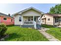 Adorable single-Gathering residence with a welcoming front porch and sidewalk at 1619 E Bradbury Ave, Indianapolis, IN 46203