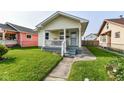 Inviting home exterior with a quaint porch, steps, and lush green lawn at 1619 E Bradbury Ave, Indianapolis, IN 46203