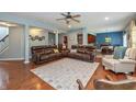 Open-concept living room with hardwood floors, comfortable seating, and dining area at 1696 Woodfield Dr, Greenwood, IN 46143