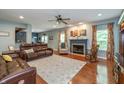 Cozy living room with a fireplace, hardwood floors, and ample natural light at 1696 Woodfield Dr, Greenwood, IN 46143