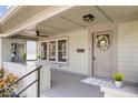 Inviting front porch featuring a wreath, a ceiling fan and beautiful brick support at 1709 Fletcher Ave, Indianapolis, IN 46203