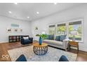 Bright living room with new floors, recessed lighting and stylish furniture at 1709 Fletcher Ave, Indianapolis, IN 46203
