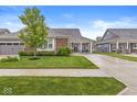 Beautiful home featuring a well-manicured lawn, mature tree, and charming covered front porch seating at 17309 Graley Pl, Westfield, IN 46074