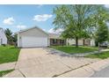 Pictured home with a wide driveway, manicured lawn, and mature trees at 17357 Austrian Pine Way, Westfield, IN 46074