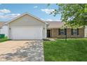 A charming one-story home with a well-kept lawn and an attached garage at 17357 Austrian Pine Way, Westfield, IN 46074