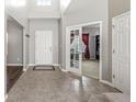 Welcoming foyer with tile flooring, a coat closet, and a view into an office with glass doors at 1829 Archbury Dr, Avon, IN 46123