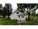 Charming home featuring a well-maintained lawn, mature trees, and concrete steps at 204 S Conger St, Saint Paul, IN 47272