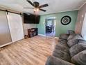 Inviting living room featuring wood flooring, a ceiling fan, and an archway to another room at 2041 Mckinley Ave, Columbus, IN 47201