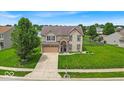 Attractive two-story home with a well-kept lawn, an attached garage, and a welcoming facade at 2434 Burgundy Way, Plainfield, IN 46168