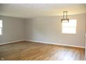 Spacious living room featuring wood floors, recessed lighting, and multiple windows for ample light at 3026 Stuart St, Indianapolis, IN 46218