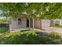 Covered front entry features sturdy support columns and a spacious front yard with healthy lawn at 3349 Capsella Ln, Indianapolis, IN 46203