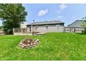 Nice backyard with a wooden deck and a fire pit perfect for outdoor gatherings at 3429 Pavetto Ln, Indianapolis, IN 46203