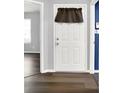 Inviting entryway featuring a white door with wood-look flooring and neutral wall color at 4007 Knollwood Ave, Franklin, IN 46131