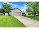 Exterior shot of a single-Gathering home showing the garage, driveway, and landscaped front lawn at 4007 Knollwood Ave, Franklin, IN 46131