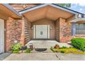 Close-up of the front entrance highlighting the double doors and brickwork of the exterior at 407 Woodland E Dr, Greenfield, IN 46140