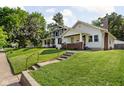 Exterior view of two homes with manicured lawns, mature trees, and inviting curb appeal at 4137 Rookwood Ave, Indianapolis, IN 46208