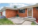 Brick home featuring large windows, a beautiful front door, and a well-maintained lawn at 418 Dunbar Dr, Indianapolis, IN 46229
