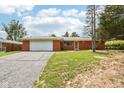 Charming brick ranch-style home featuring an attached two-car garage and a well-maintained front yard at 418 Dunbar Dr, Indianapolis, IN 46229