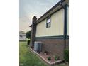 Exterior side view of a two-story brick and siding home with a well-maintained lawn and garden at 4928 Dancer Dr, Indianapolis, IN 46237