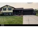Charming two-story home with brick and siding exterior, and a well-manicured lawn and driveway at 4928 Dancer Dr, Indianapolis, IN 46237
