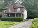 Two-story home with a mix of brick and siding, featuring a lovely front porch at 5010 Melbourne Rd, Indianapolis, IN 46228