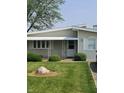 Charming single-story home featuring a well-maintained lawn and awning-covered entry at 520 E County Road 500 S, Muncie, IN 47302