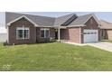 Charming brick home with well-kept lawn and landscaped yard in a friendly neighborhood at 5755 Victory Dr, Columbus, IN 47203
