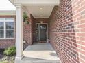 Covered front porch with brick columns and decorative accents, creating a welcoming entrance at 5755 Victory Dr, Columbus, IN 47203