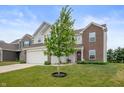 Traditional two-story home with a well-maintained front yard with a tree at 5794 Wintersweet Ln, Whitestown, IN 46075