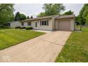 Charming ranch-style home featuring a well-maintained lawn, long driveway, and an attached one car garage at 6408 Old Mill Dr, Indianapolis, IN 46221