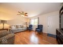 Bright living room featuring hardwood floors, a ceiling fan, comfortable seating, and lots of natural light at 6408 Old Mill Dr, Indianapolis, IN 46221