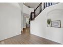 Bright foyer with hardwood floors, white walls, staircase and decorative niche at 6524 Turning Leaf Ln, Indianapolis, IN 46236