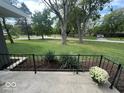 A view of the lush front yard with landscaped garden and manicured lawn at 6805 Twin Brooks Dr, Indianapolis, IN 46227