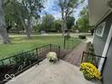 A view of the lush front yard with landscaped garden, brick walkway and manicured lawn at 6805 Twin Brooks Dr, Indianapolis, IN 46227