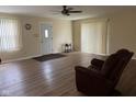 Inviting living room featuring wood-look floors and a comfortable armchair at 705 Orchard Ln, Greenwood, IN 46142