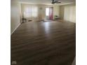 Open living room featuring vinyl flooring, neutral walls, and a ceiling fan at 705 Orchard Ln, Greenwood, IN 46142