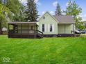 Spacious backyard with a lush green lawn, an enclosed porch, and a well-maintained exterior at 720 Blanchard St, Shelbyville, IN 46176