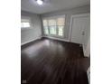 This light-filled bedroom features new flooring, fresh paint, and bright windows with mini blinds at 733 Haugh St, Indianapolis, IN 46222