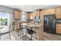 Open kitchen with an island, stainless steel appliances, wood cabinets and a view of the lake at 733 Reunion Ln, Greenwood, IN 46143