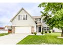 Charming two-story home with a well-manicured lawn and attached two-car garage at 7546 Kidwell Dr, Indianapolis, IN 46239