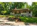 Charming home with covered porch, concrete steps, and professional landscaping at 8717 Moore Rd, Indianapolis, IN 46278