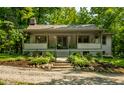 Charming home with a covered porch, featuring concrete steps and manicured landscaping at 8717 Moore Rd, Indianapolis, IN 46278
