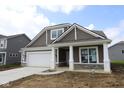 Beautiful home exterior showcasing neutral siding, white trim, and well-maintained landscaping at 10132 Redwood Peak Ln, Indianapolis, IN 46259