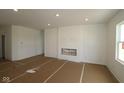Spacious living room with neutral walls, recessed lighting, and a cozy fireplace nook ready for personalization at 10132 Redwood Peak Ln, Indianapolis, IN 46259