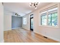 Light-filled living room boasting hardwood floors, fresh white walls, and a modern ceiling fan and lighting at 1021 N Alabama St, Indianapolis, IN 46202