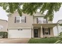 A charming two-story home featuring a two-car garage, inviting entrance, and well-manicured front yard at 10510 Mcclain Dr, Brownsburg, IN 46112